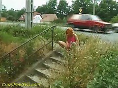 Chick accepts a piss next to a public street