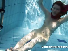 Redhead Mia is tripping underwater