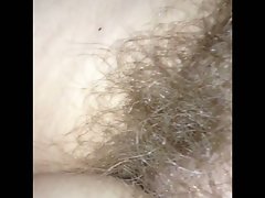 rubbing her natural bushy pussy,