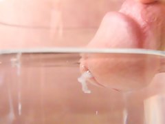 Close-up cumshot of circumcised pecker in water