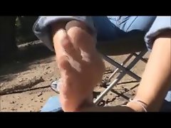 Vixen giving footjob on the beach-black toes.