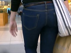 Candid butt in narrow jeans and boots