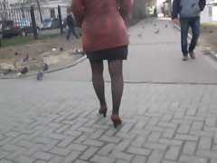 Chick flashing stockings walking on a street