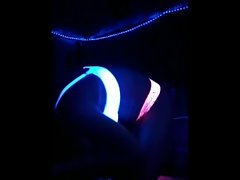 She can't resist and spins around for the black light blowjob