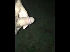 Pissing outdoors in the grass